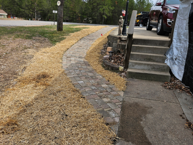 Brick paver sidewalk going out to a street.